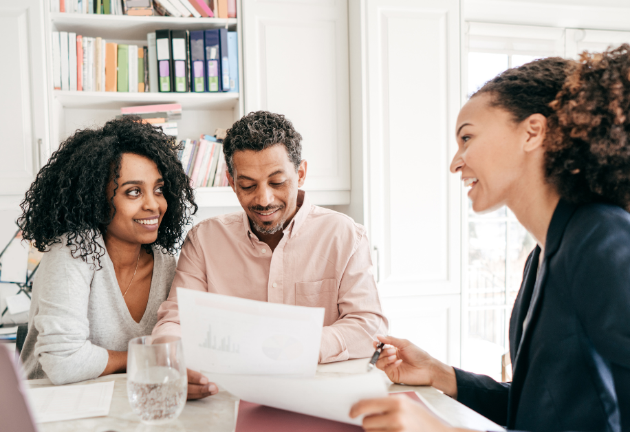 A couple speaking with a small business loan specialist