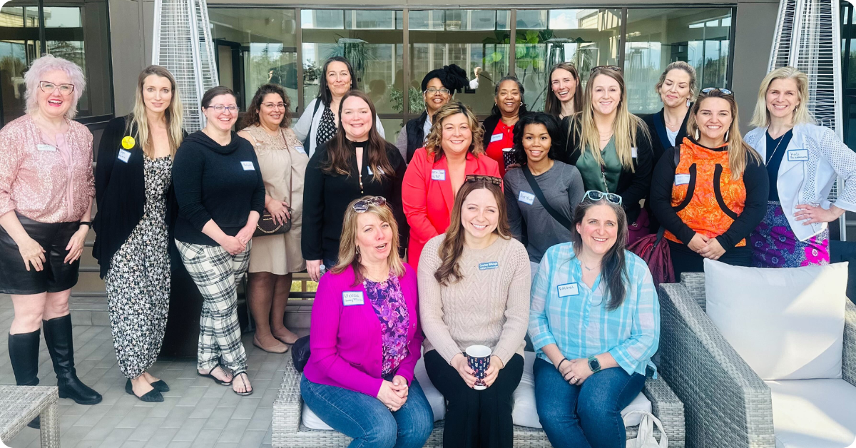 A large group of diverse women entrepreneurs in Alaska posing at an event.