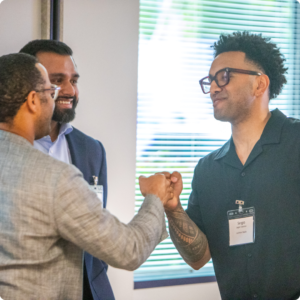 Two men fist bumping at the Port of Seattle introduction event. 