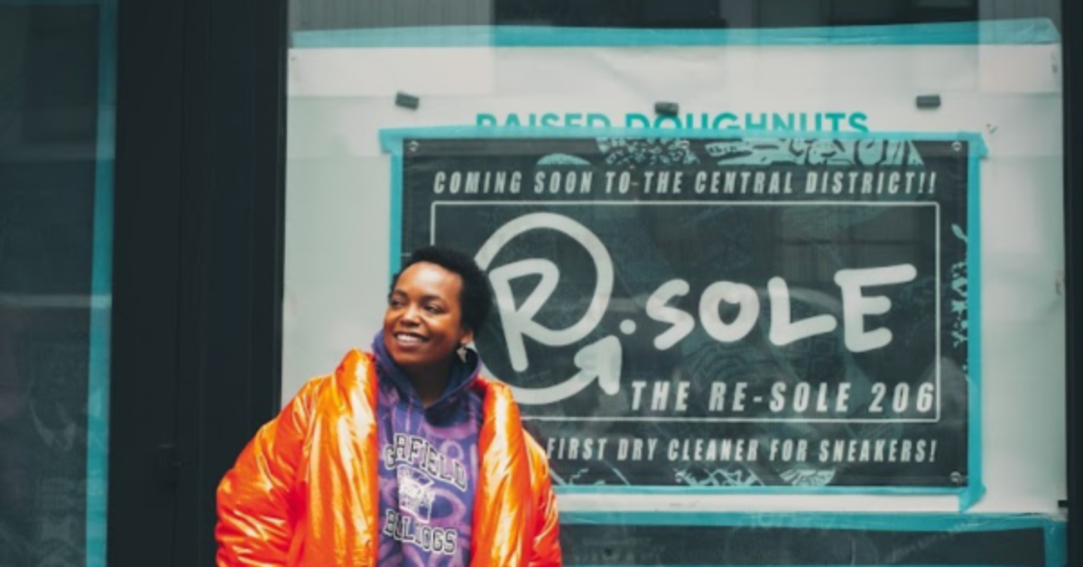 Photo of Takiyah Ward in front of her new business space for the Resole 206