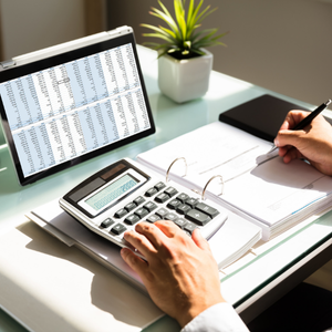 Someone using a calculator or reviewing invoices