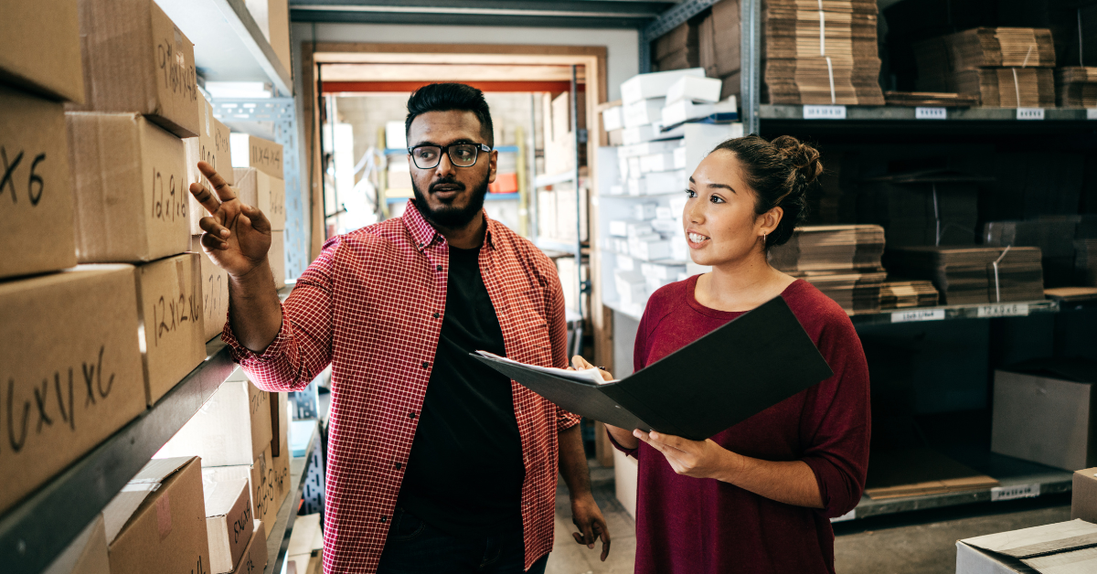 Two business owners doing inventory in a warehouse